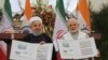INDIA -- Indian Prime Minister Narendra Modi, right, with Iranian President Hassan Rohani release a postal stamp commemorating growing economic and trade ties between the two nations in New Delhi, February 17, 2018