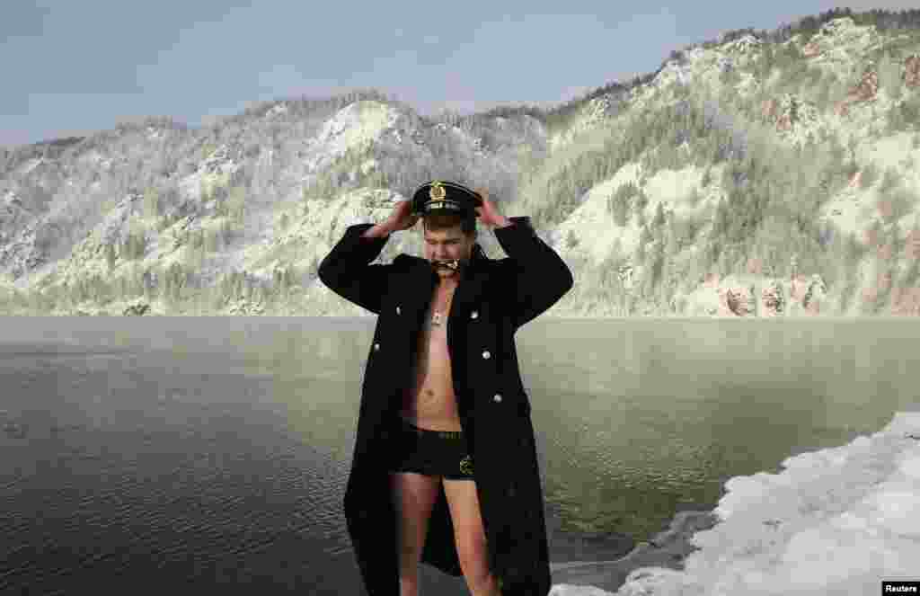 Dmitry Borisov, a recently demobilized Russian Northern Fleet sailor, reacts after bathing in the Yenisei River in air temperature around minus 17 degrees Celsius near the Siberian town of Divnogorsk. Borisov commissioned the photo session to mark his return to his native town after military service. (Reuters/Ilya Naymushin)