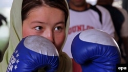 A female boxer takes part in a practice session in preparation for the London 2012 Olympics at a gym in Kabul.