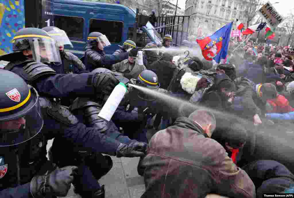 French riot police spray tear gas on demonstrators during clashes on the Champs-Elysees in Paris. Thousands demonstrated against France&#39;s gay marriage law in an attempt to block legislation that will allow homosexual couples to marry and adopt children. (AFP/Thomas Samson)