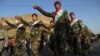 Kurdish Peshmerga fighters in Irbil take part in a rally in support of an independence referendum.