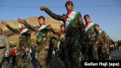 Kurdish Peshmerga fighters in Irbil take part in a rally in support of an independence referendum on September 13.