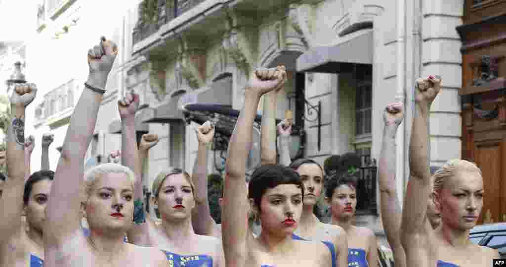 Topless activists of the Ukrainian Femen movement raise their fists during an antifascism protest in Paris. (AFP/Thomas Samson)