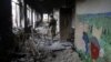 A Ukrainian serviceman walks through a destroyed school in the village of Pisky near Donetsk late last year.