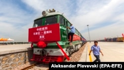 Railway workers prepare the first block train for departure from Shijiazhuang, China, to Moscow in the port in Hebei Province in June 2018, just one part of the sprawling Belt and Road Initiative.