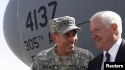 U.S. General David Petraeus (left) greets Defense Secretary Robert Gates in Kabul.