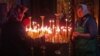 Two elderly women place prayer candles in Kyiv's St. Michael's monastery on Easter Sunday. 