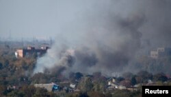 Smoke rises above a residential area after recent shelling near Donetsk airport during fighting between pro-Russian separatists and Ukrainian government forces. 