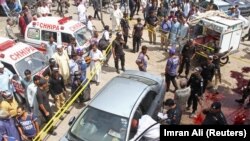 Police officers inspect a car after unidentified gunmen carried an attack on a prominent Pakistani cleric, in Karachi on March 22.