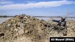 A farmer in Karoon City in Khuzestan points to his destroyed home. April 2019.