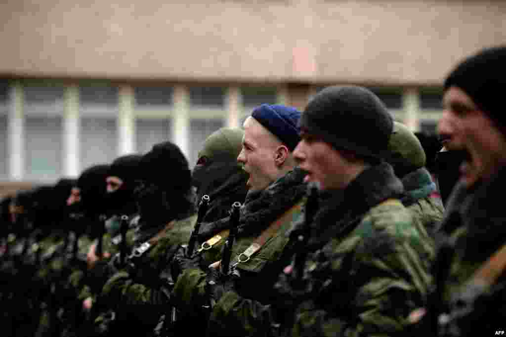 Pro-Russian forces dubbed the "military forces of the autonomous republic of Crimea" attend their swearing-in ceremony in Simferopol on March 10. (AFP/Filippo Monteforte)