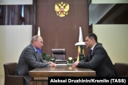 Russian President Vladimir Putin (left) meets with Mikhail Vedernikov, the newly-appointed acting governor of the Pskov Region, in Sochi, on October 12.