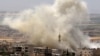 Smoke plumes follow reported air strikes on the town of Khan Sheikhun in the southern countryside of the rebel-held Idlib Province on June 3.