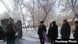 Activists lay flowers in memory of victims of the Zhanaozen unrest in the Kazakh city of Karaganda, one year after the massacre.