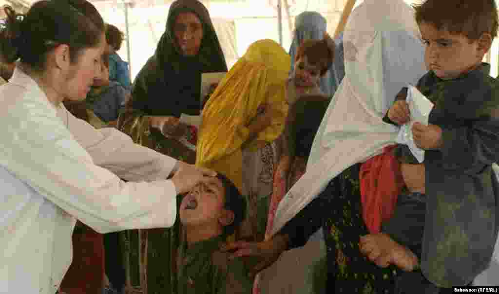 A doctor administers vaccines to children at a hospital in Kabul.