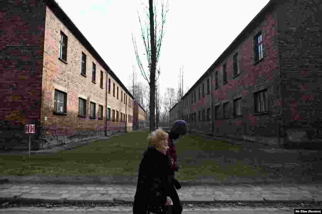 Jona Laks and her granddaughter walk as they visit the Auschwitz death camp. Jona Laks recalls that&nbsp; when they arrived to&nbsp;Auschwitz they underwent &lsquo;selection&rsquo;: as they lined up on the platform, an SS doctor would choose who was fit for camp labor and who was to be killed in the gas chambers. Joseph Mengele, Auschwitz&rsquo;s &ldquo;Angel of Death&rdquo;, carrying out selection that day. &ldquo;Eventually Mengele came over with his dogs and his stick in his hand, &lsquo;left, right, left, right&rsquo;, I don&rsquo;t think he was even looking at the people. He looked bored,&rdquo; Laks recalled with a slight smirk of contempt.