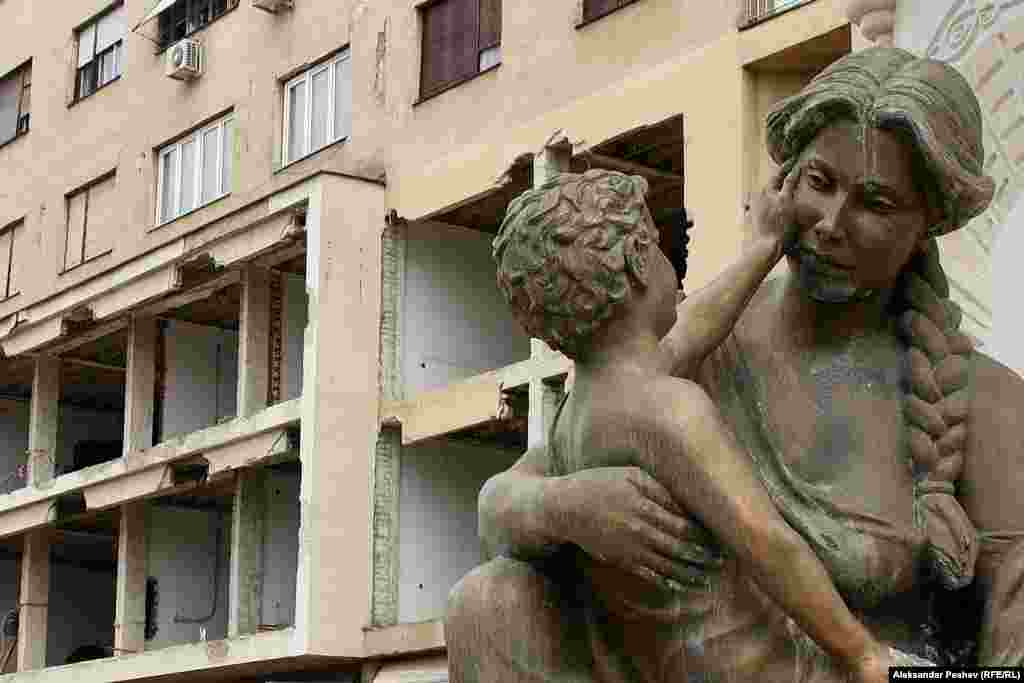 An unfinished facade of a cultural center on Skopje&#39;s central square is due to be reconstructed in a neoclassical style. The sculpture in the foreground is one of many surrounding a large statue of Philip of Macedon, the father of Alexander the Great.