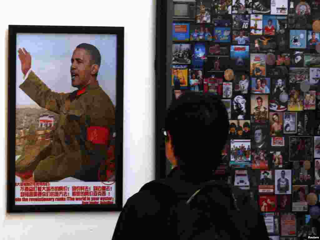 A visitor looks at a work on display showing the head of U.S. President Barack Obama superimposed onto the body of former Chinese chairman Mao Zedong in Beijing. (REUTERS/David Gray)