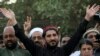 FILE: Leader of Pashtun Protection Movement (PTM) Manzoor Pastheen (C) waves to supporters during a demonstration in Lahore (April 2018)