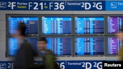 Passengers arrive at Charles de Gaulle Airport outside Paris, where flights resumed on April 20.