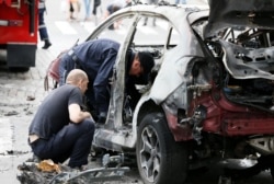 Investigators inspect Sheremet's car at the site where he was killed in central Kyiv on July 20, 2016.