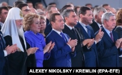 The audience of senior government and elected officials repeatedly interrupted Putin with applause.