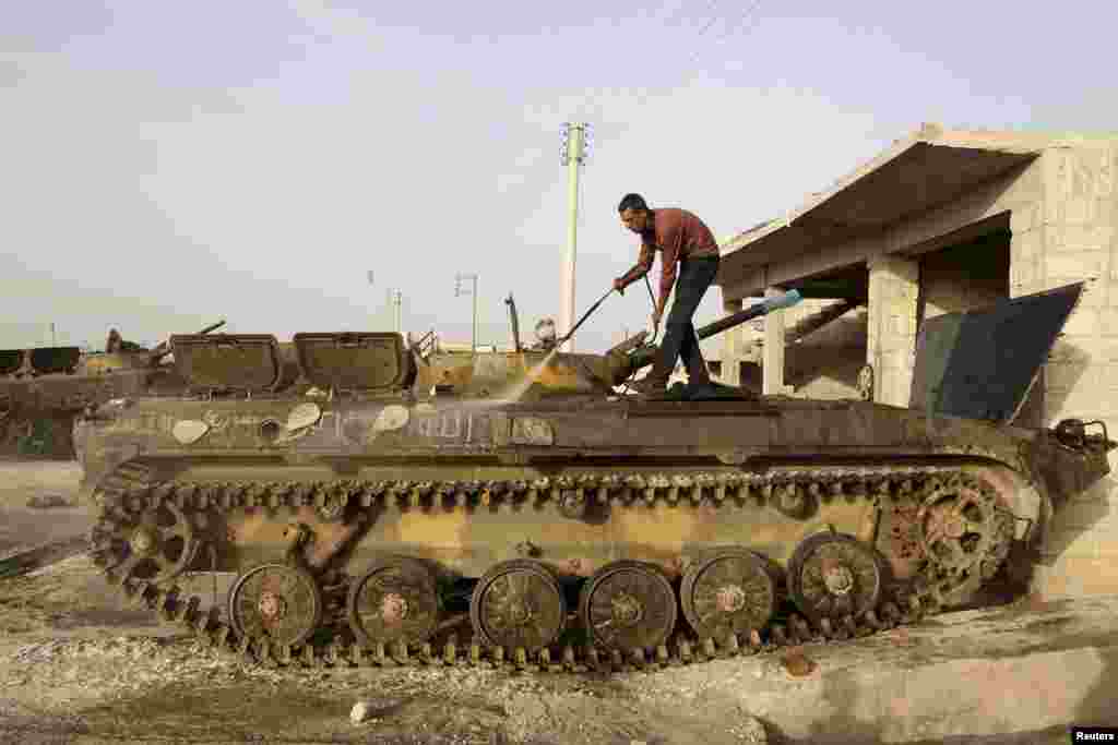 A man washes a tank in Azaz near Aleppo, Syria. (Reuters/Muzaffar Salman)