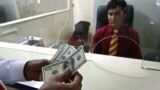 Klijent broji novac nakon podizanja u filijali Aa banke u Kabulu. (arhivska fotografija)