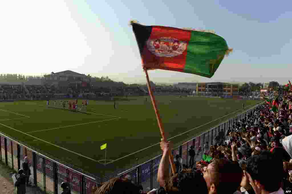 Afghan fans celebrate following their team&#39;s second goal against Pakistan at the Afghanistan Football Federation Stadium in Kabul on August 20.