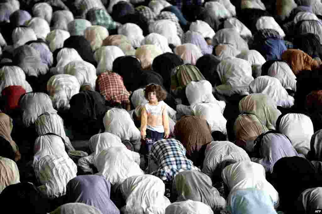 A girl stands among worshipers during Friday Prayers at Tehran University in Iran. (AFP/Behrouz Mehri)