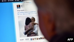 Italy -- A man reads Barack Obama's tweet in Rome after his re-election as US president, 07Nov2012