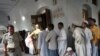 Voters wait outside a polling station in Varanasi.