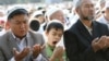 A boy yawns during Islamic prayers at a square in the Kyrgyz capital, Bishkek.
