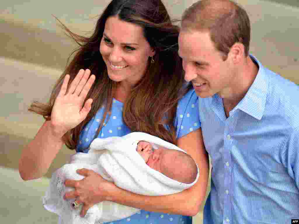 Prince William and Catherine, duchess of Cambridge, show their newborn baby boy to the world's media outside the Lindo Wing of St. Mary's Hospital in London. The baby is third in line to the throne. (AFP/John Stillwell)