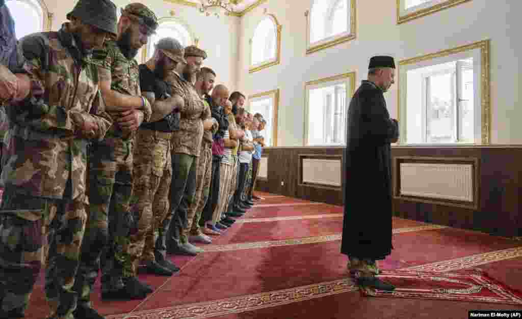 Former mufti Sheikh Said Ismahilov leads Ukrainian Muslim soldiers during prayers on the first day of Eid al-Adha in Medina mosque in the eastern town of Kostyantynivka in the Donetsk region on July 9.