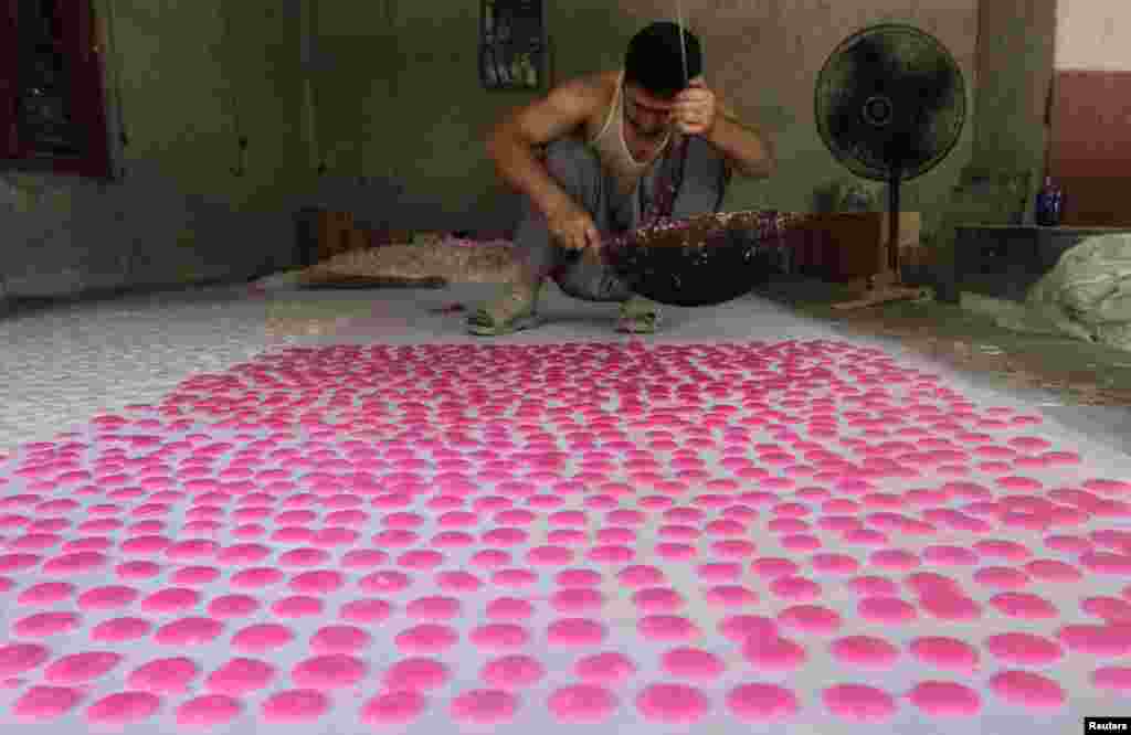 An Afghan man makes special confectionery at a traditional sweets factory in Jalalabad on August 4. (Reuters/Parwiz)