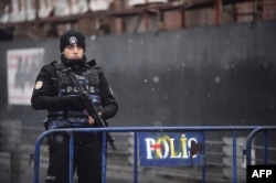 A Turkish police officer stands guard close to the Reina nightclub.