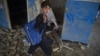 FILE: An Afghan schoolboy carries his backpack at a school near the site of a Taliban car bomb attack in Kabul in July.