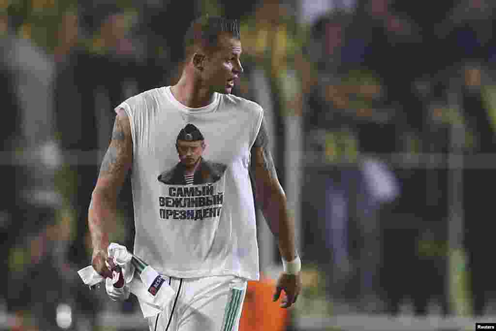 Lokomotiv Moscow's Dmitri Tarasov wears a T-shirt depicting Russian President Vladimir Putin and the slogan, "Most Polite President." Lokomotiv may face disciplinary action from European soccer's ruling body, as political statements are not allowed at competitions. Ties between Turkey and Russia have been tense since November when Turkey shot down a Russian warplane near its border with Syria. Fenerbahce won the match 2-0. (Reuters/Murad Sezer) 