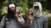 Former Taliban militants are shown turning over their weapons during a reconciliation ceremony in Jalalabad, Afghanistan, on September 3.