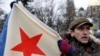 A man hold a Soviet-era military flag during a pro-Russian rally in Simferopol, Crimea, on February 28.