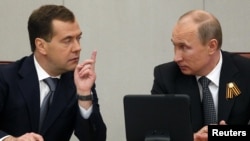 Could a generation gap be emerging in the Kremlin with a disconnect between older cronies of President Vladimir Putin (right) and younger individuals linked with Prime Minister Dmitry Medvedev? 