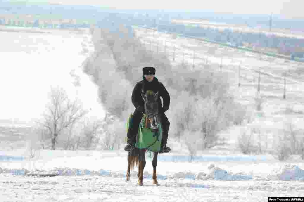 A mounted police officer keeps an eye on the event.