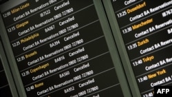 An electronic board shows flight cancellations at Heathrow Airport's Terminal 5 in London on April 15.