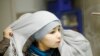 Sanaa, 10, puts on her hijab as she gets ready for Islamic Saturday school in Leyton, east London. She occasionally wears the hijab on regular school days. Dalila, Sanaa&#39;s mother, says: &quot;she may start to wear the head scarf every day next year. Sanaa will decide for herself when she&#39;s ready to wear it every day.&quot;