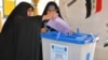 An Iraqi woman casts her ballot in Karbala on April 20.