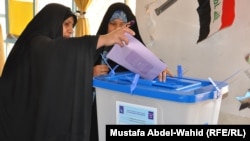 An Iraqi woman casts her ballot in Karbala on April 20.