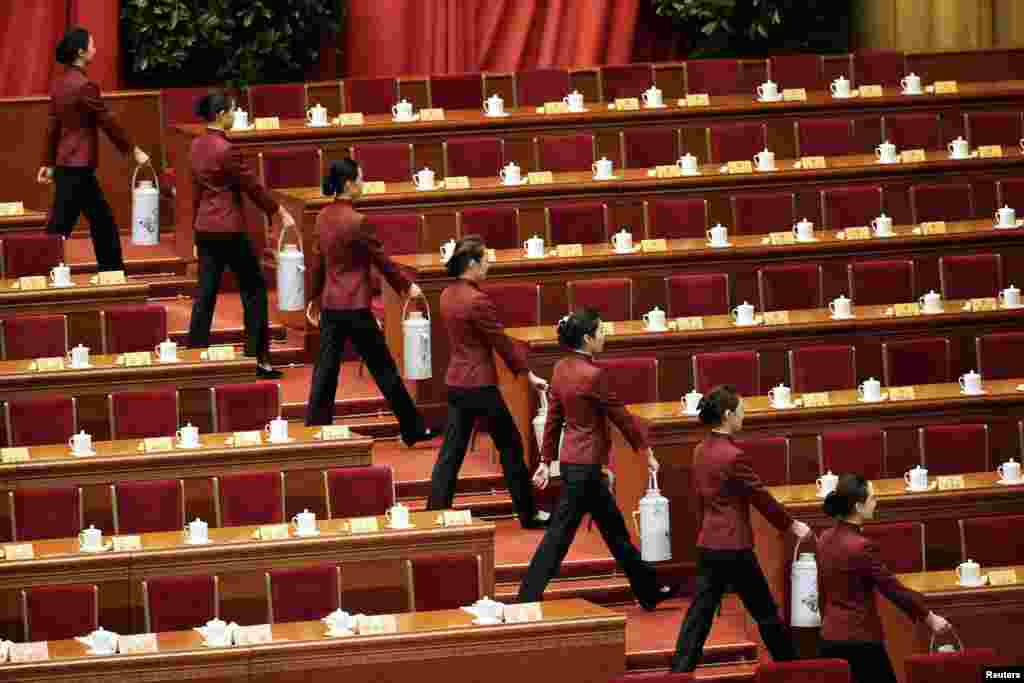 Attendants carry tea for delegates ahead of the opening session of the Chinese People's Political Consultative Conference in the Great Hall of the People in Beijing. (Reuters/Jason Lee)