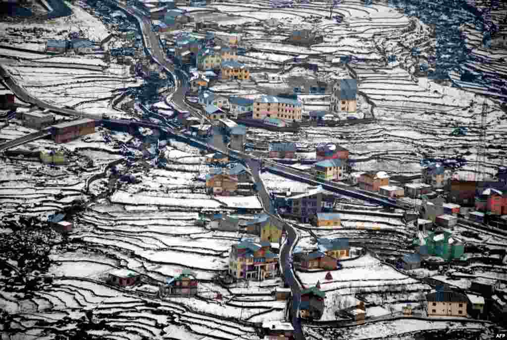 A view of snow-covered fields and villages in the Bhaderwah Valley of India, some 200 kilometers east of Jammu. (AFP)