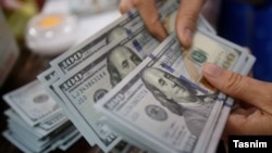 U.S. dollar bills being counted at an exchange office in Iran. FILE PHOTO